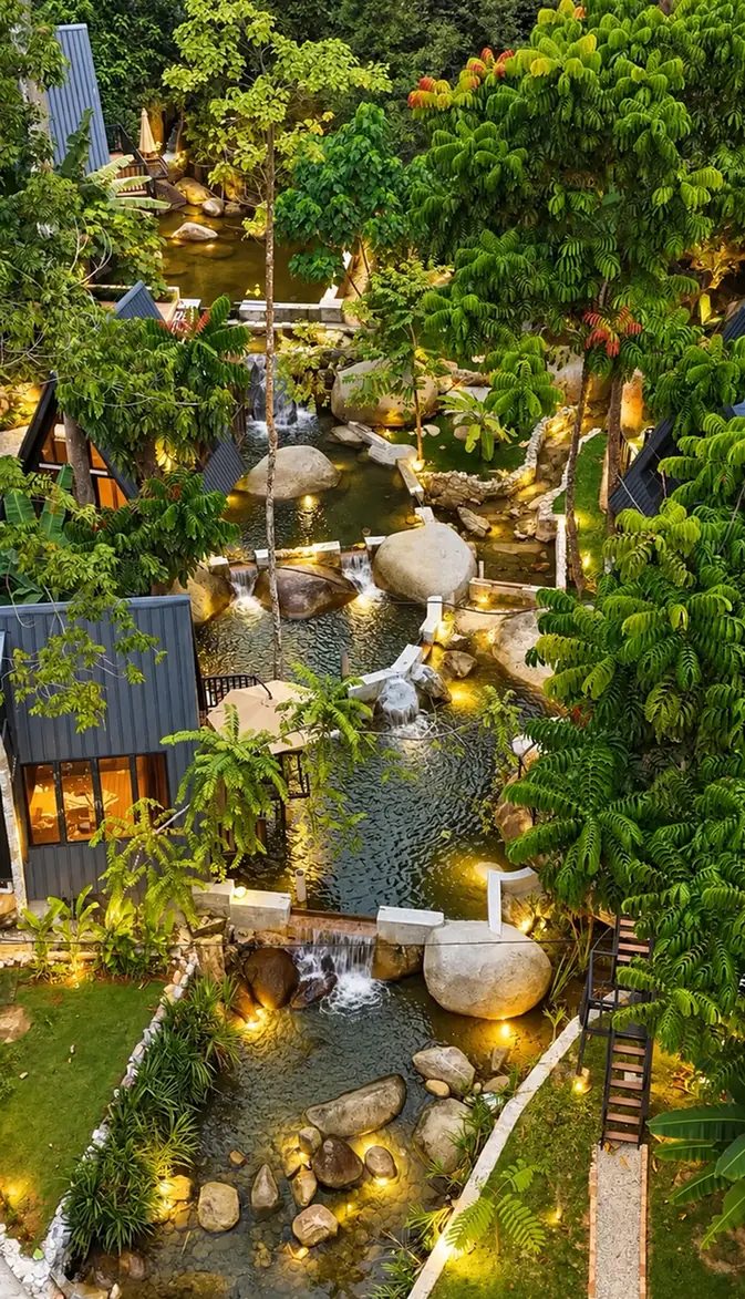River, boulders and tropical planting between the stays at Terra Tara